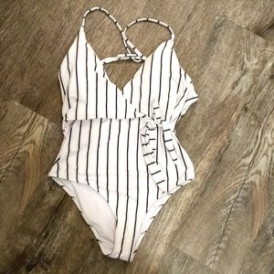 One piece suit, tag still attached